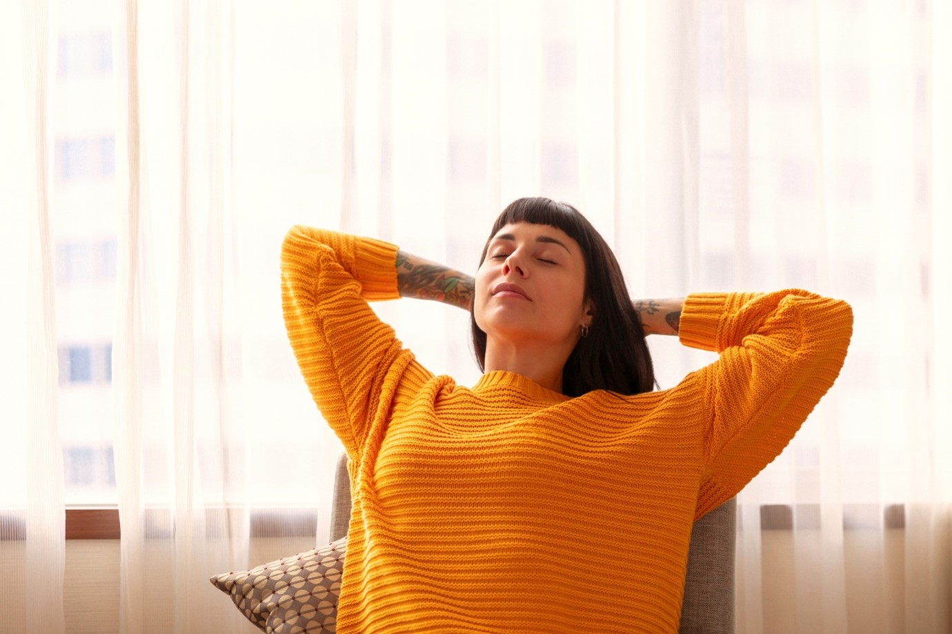 Woman with brown hair in orange sweater