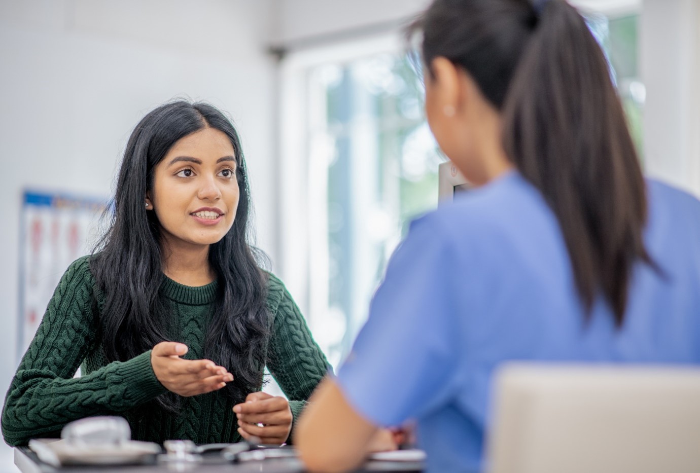 A woman discussing Contraception choices with a healthcare provider.